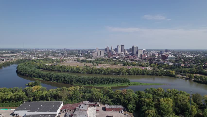 Population and capital city center of Columbus, OH, with aerial view of Scioto river, buildings, skyscrapers, business, traffic, metro parks, and Ohio people on a sunny summer day