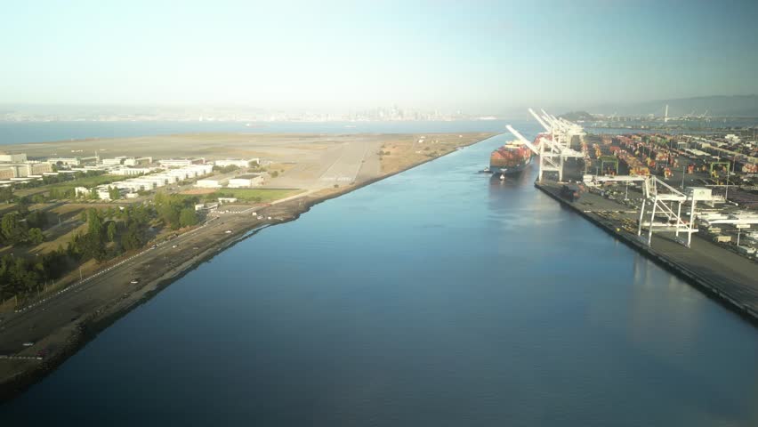 An aerial drone push in sjpt that showcases Alameda Point and Point of Oakland from the Oakland Inner Harbor.