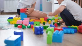 Young girl and her baby sister are happily engaged in building towers and structures with colorful toy blocks in their cozy nursery, surrounded by creativity and joy during playtime - Powered by Shutterstock - Get 15% off with code: PIKWIZARD15