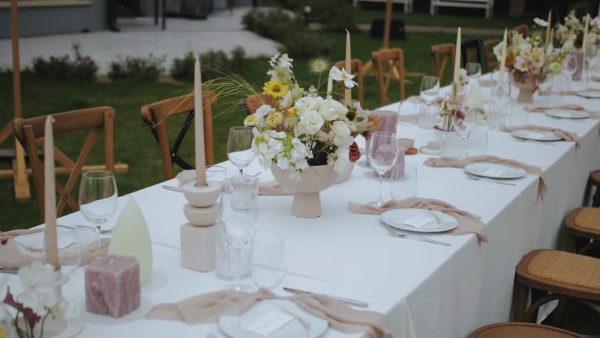 Beautiful and Elegant Outdoor Wedding Table Setting Featuring Lovely Floral Decor and Details