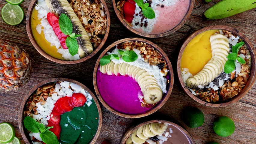 Top View Colorful Smoothie Bowls with Fresh Fruits Granola and Vibrant Toppings for Healthy Life. Close-up One Wooden Table with Yogurt Bowl and Organic Vitality. A lot of Ingredients Balanced Food 4k