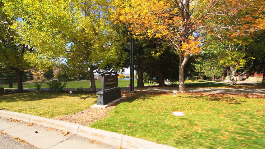 Avon Colorado small town by Nottingham park and lake, car pov point of view road driving by people on sunny autumn fall day