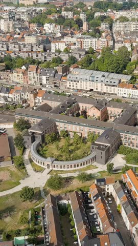 Vertical video. Ghent, Belgium. Binnentuin Lousbergpark - garden. Panorama of the central city from the air. Cloudy weather, summer day, Aerial View, Point of interest
