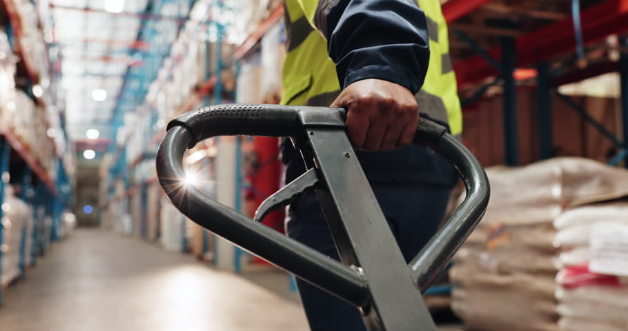 Logistics, hands or worker with trolley in warehouse for package distribution, supply chain or delivery products. Back, inventory or person pulling pallet jack in factory for storage stock or walking