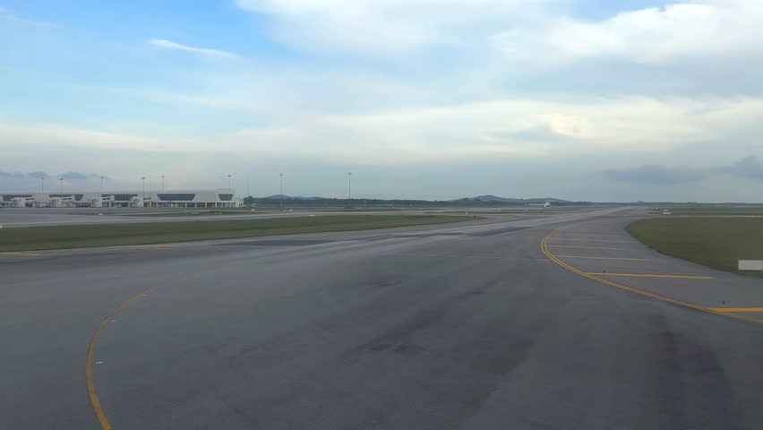 Airplane moving on a runway. Airplane taxiing for takeoff. Airport terminals with planes on runway. Plane taxiing at airport. Kuala Lumpur, Malaysia.