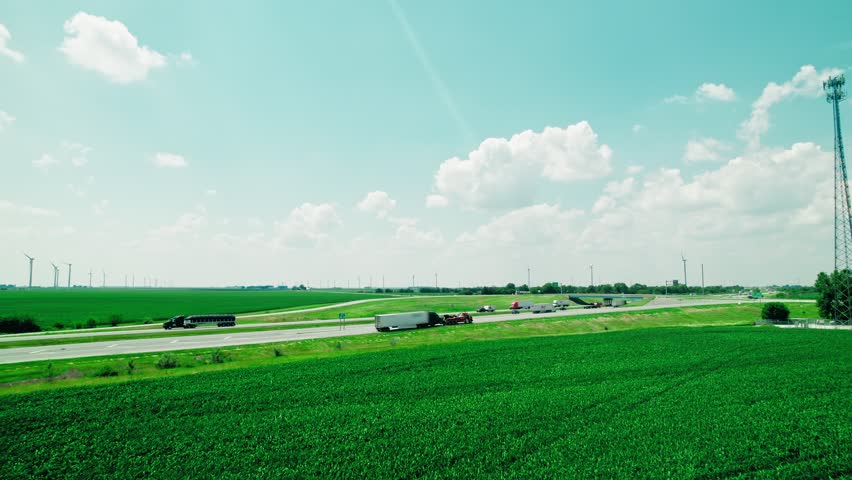 Aerial of Broken Semi truck Meets Wind Farm: Towing Service in Action. Indiana, USA