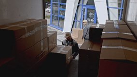 Delivery workers loading truck with cardboard boxes. Media. Putting parcels into van, concept of professional courier, delivering purchased items efficiently. - Powered by Shutterstock - Get 15% off with code: PIKWIZARD15