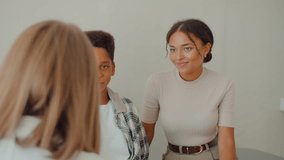 Back view blond woman sitting in front of female and boy sitting on couch in medical room. Young mom bringing preteen son to consultation with doctor and listening attentively to advices. - Powered by Shutterstock - Get 15% off with code: PIKWIZARD15