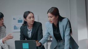 Three businesswomen engage in a heated discussion about work while focusing on a laptop during a business meeting, showcasing their strong emotions and professional dynamics - Powered by Shutterstock - Get 15% off with code: PIKWIZARD15