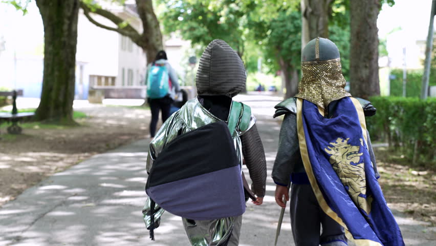 Back view of two children dressed as knights, strolling through a park, heading towards their next imaginative adventure. the playful spirit and curiosity of childhood