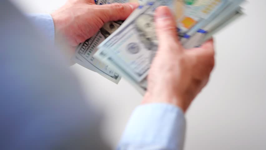 Male hands counting US Dollar bills, close-up - Powered by Shutterstock - Get 15% off with code: PIKWIZARD15