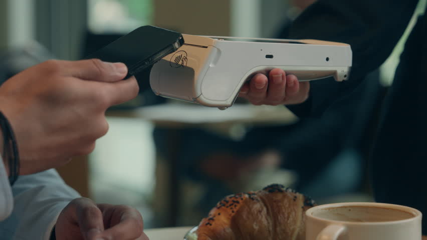 Close up hands visitor man pay bill food order in cafe restaurant unrecognizable waiter holding terminal wifi scan using smartphone contactless NFC payment cashless client service mobile phone bank