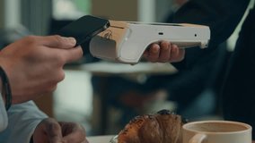 Close up hands visitor man pay bill food order in cafe restaurant unrecognizable waiter holding terminal wifi scan using smartphone contactless NFC payment cashless client service mobile phone bank - Powered by Shutterstock - Get 15% off with code: PIKWIZARD15