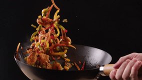 Chef cooking shrimps with mix vegetables on wok frying pan close-up. Prawns on fire throwing them on pan. Restaurant Food concept. Sea food. - Powered by Shutterstock - Get 15% off with code: PIKWIZARD15