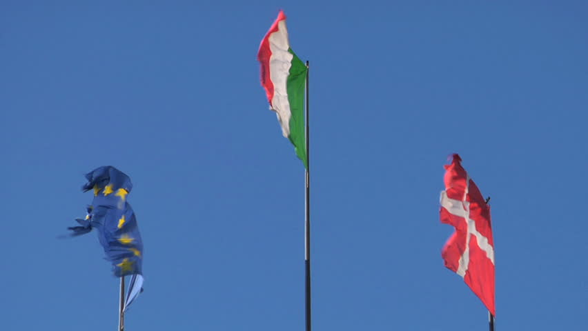 EU, Italy and Denmark flag in slow motion on blue sky
