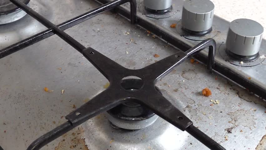 Close up view of the dirty gas stove.
