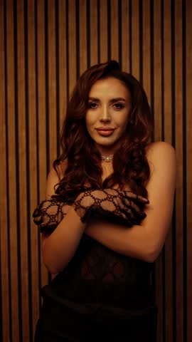 Woman in black dress and fishnet gloves. Concept of seduction and flirting.