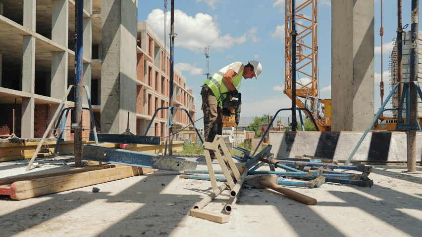 Construction Worker Using Power Tool on Site. A construction worker operates a power tool while working on an outdoor construction site. - Powered by Shutterstock - Get 15% off with code: PIKWIZARD15
