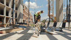 Construction Worker Using Power Tool on Site. A construction worker operates a power tool while working on an outdoor construction site. - Powered by Shutterstock - Get 15% off with code: PIKWIZARD15