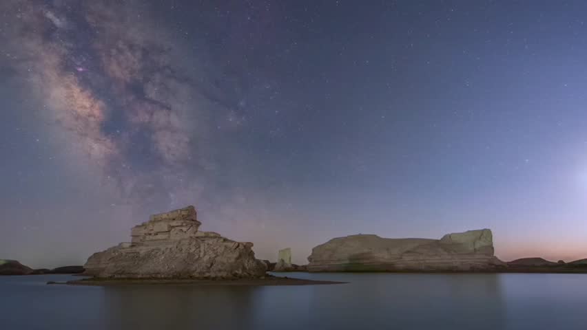 Time lapse shot of Milky Way over mountain against sky at night