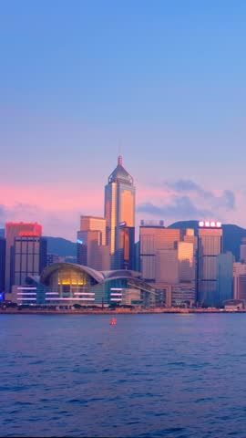 Hong Kong skyline cityscape downtown skyscrapers over Victoria Harbour illuminated in the evening. Hong Kong, China