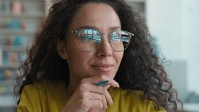 Latina Caucasian Hispanic woman glasses looking away think idea inspiration writing notebook library learning writer author journalist knowledge graduate brain cognition academic university motivation - Powered by Shutterstock - Get 15% off with code: PIKWIZARD15