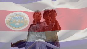 Animation of flag of costa rica over biracial female couple embracing. Patriotism, lifestyle and digital interface concept digitally generated video. - Powered by Shutterstock - Get 15% off with code: PIKWIZARD15