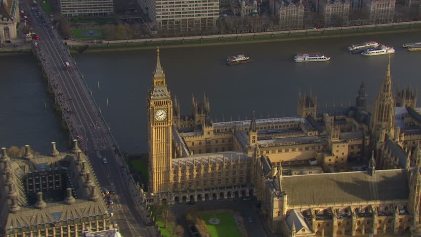 Aerial view flying over the Houses of Parliament and the Westminster bridge in London, England on a bright and sunny autumn day. The bridge joins the city of Westminster and the borough of Lambeth.  Royalty-Free Stock Footage #3584816