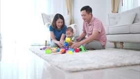 Parents and their little child play happily in the living room of the house - Powered by Shutterstock - Get 15% off with code: PIKWIZARD15