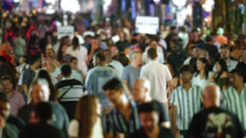 Many people walk Thai city street. Fun Thailand night life. Rush hour crowd. Lots of drunk tourist hang out nightclub. Busy pedestrian pass by nightlife bar. Urban neon light sign. Public club hopping