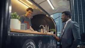 African Customer in a Suit Pays for Take Away Coffee with Contactless NFC Payment Technology on His Smartphone. Friendly Barista Works in a Street Cafe. Customer Applying Cellphone to a Bank Terminal - Powered by Shutterstock - Get 15% off with code: PIKWIZARD15