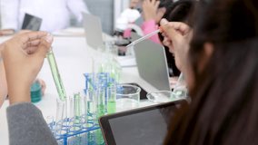 Close-up elementary boys and girl school kids students have fun studying sitting in laboratory classroom enjoy mixing liquid substance experiments, education happy learning by doing in private school - Powered by Shutterstock - Get 15% off with code: PIKWIZARD15