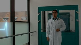 Animation of cardiograph over biracial male doctor walking in hospital. Global medicine, healthcare, science, computing and digital interface concept digitally generated video. - Powered by Shutterstock - Get 15% off with code: PIKWIZARD15