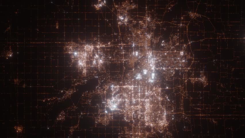 Des Moines (Iowa, USA) top view at night. Aerial view on modern city with lights. Camera is flying above the city, moving backward. Vertical video. The north is on the left side