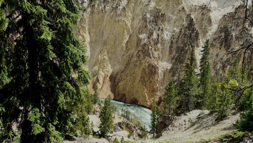 Yellowstone Park with rushing geysers, multicolored hot springs, crystal clear lakes and impressive canyons. Bears and bison. Wyoming, Idaho and Montana. Yellostone natural spectacle. Sunset.