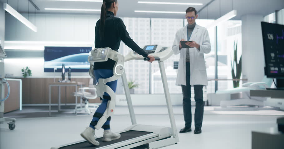 Advanced Physical Rehabilitation in a Futuristic Medical Lab Using an Exosuit on a Treadmill, Monitored by a Doctor. Advanced Technology Enhances Recovery Possibilities Through Innovative Research.