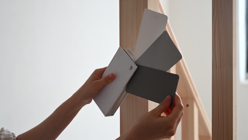 Comparing paint swatches for a home interior renovation of wooden ladder. Finding the perfect shade for design project
