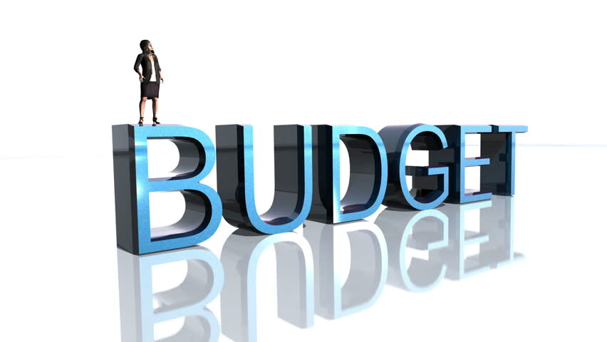 Business Woman stands on top of Budget text