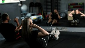 Two middle-aged athletes exercising together in fitness. Attractive handsome sportsman and sportswomen doing sit-up cardio workout to maintain strong muscle for health care in gym club. - Powered by Shutterstock - Get 15% off with code: PIKWIZARD15
