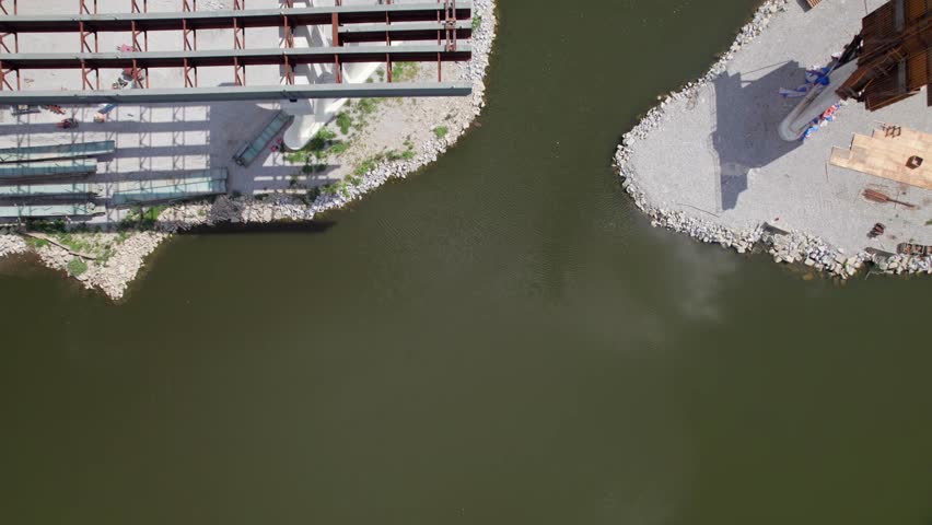 Drone aerial of new highway and multi land interstate construction coming soon and being built next to downtown and city center of Columbus, Ohio with turnpike car traffic and workers near buildings
