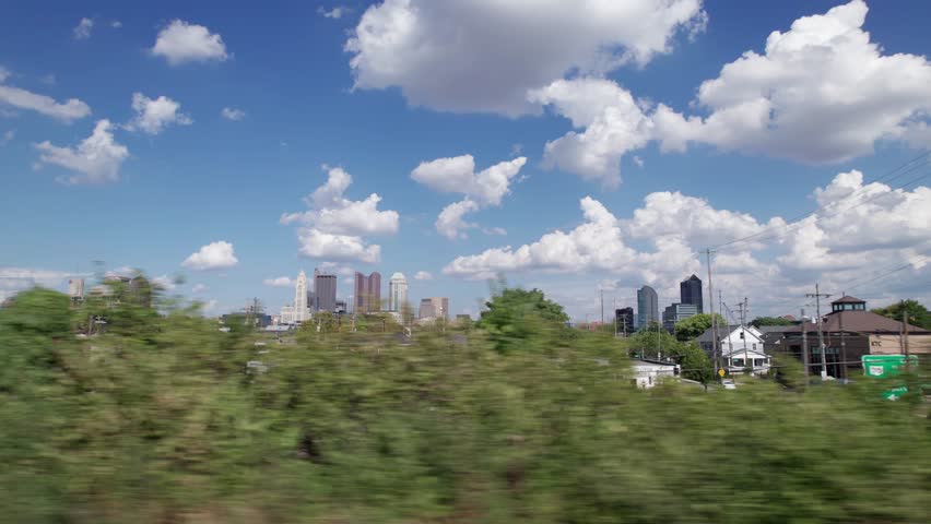 Drone aerial of cityscape, buildings, skyscrapers, and high-rises of capital city of Columbus, Ohio in United States, with new Peninsula and Franklinton construction and homes in the foreground