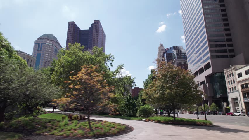 Ohio Statehouse and capitol building in city center of Columbus, OH as car drives by, with historic and political significance with architecture, legislation, statues, and governor of Midwest State