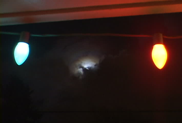 Full Moon with great storm layering clouds over night skyline with Christmas