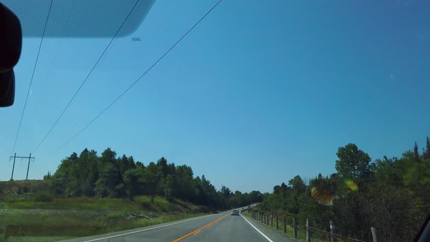 Driving along a scenic road towards Sudbury in Ontario, Canada.