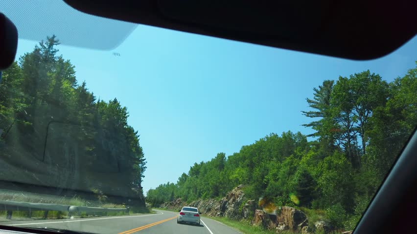 Driving along a scenic road towards Sudbury in Ontario, Canada.