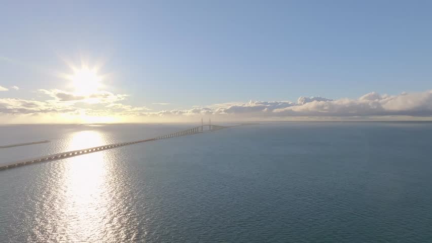 Aerial view of the majestic Skyway Bridge over the calm Tampa Bay with a picturesque sunset, St Petersburg, United States.