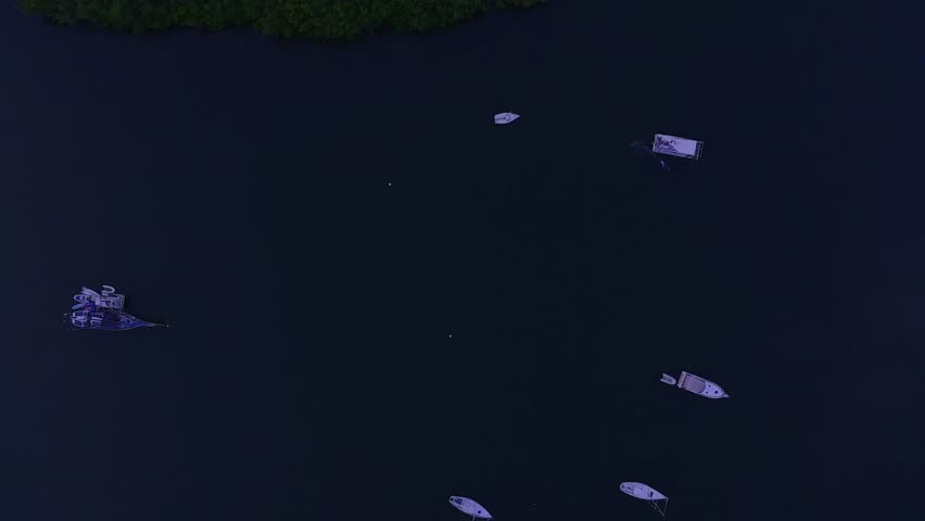 Aerial view of serene Biscayne Bay with tranquil Oleta River State Park and boats among lush greenery, Bay Harbour Islands, United States.