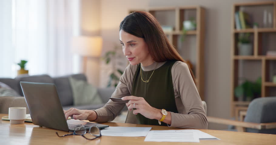 Happy woman, laptop and online banking with credit card for virtual payment or remote shopping at home. Young, female person or shopper with smile, debit or computer for internet purchase or finance