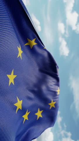 Wavy flag of European Union blowing in the wind in slow motion. Waving official Europe EU flag team symbol abstract vertical background. Blue sky with clouds. World countries flying flags concept