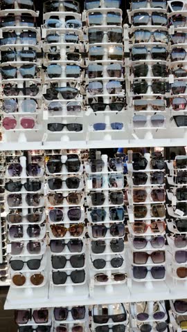 Sunglasses Shop. Display cabinet in store selling eyeglasses. Vertical format video